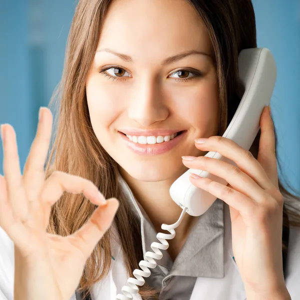 Young doctor on phone, at office — Stock Photo, Image