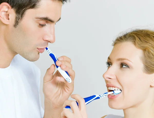 Alegre jovem casal limpeza dentes juntos — Fotografia de Stock