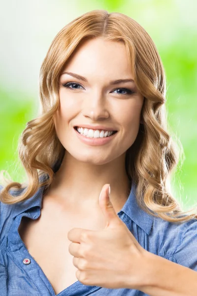 Happy woman with thumbs up gesture, outdoor — Stock Photo, Image