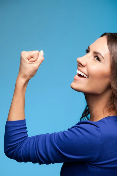 Happy gesturing young woman, over blue — Stock Photo, Image