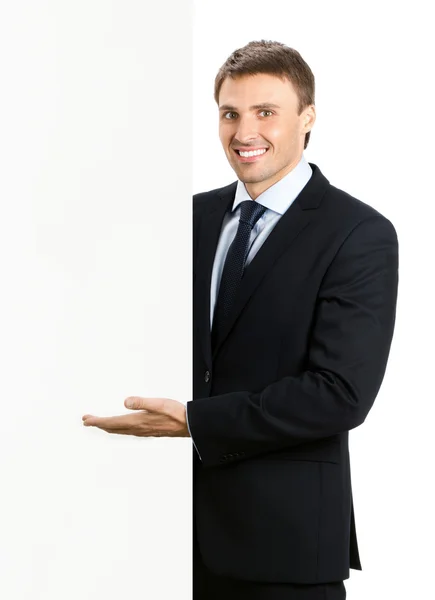 Бізнесмен, що показує вивіску, ізольований — стокове фото