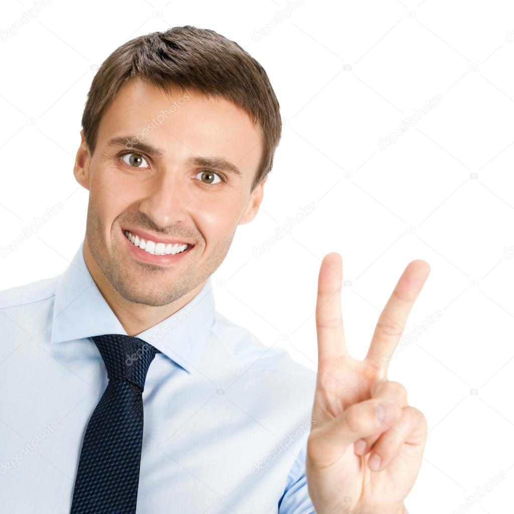 Happy smiling young business man showing two fingers or victory 