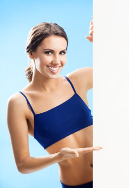 Woman in fitnesswear showing signboard, over blue clipart