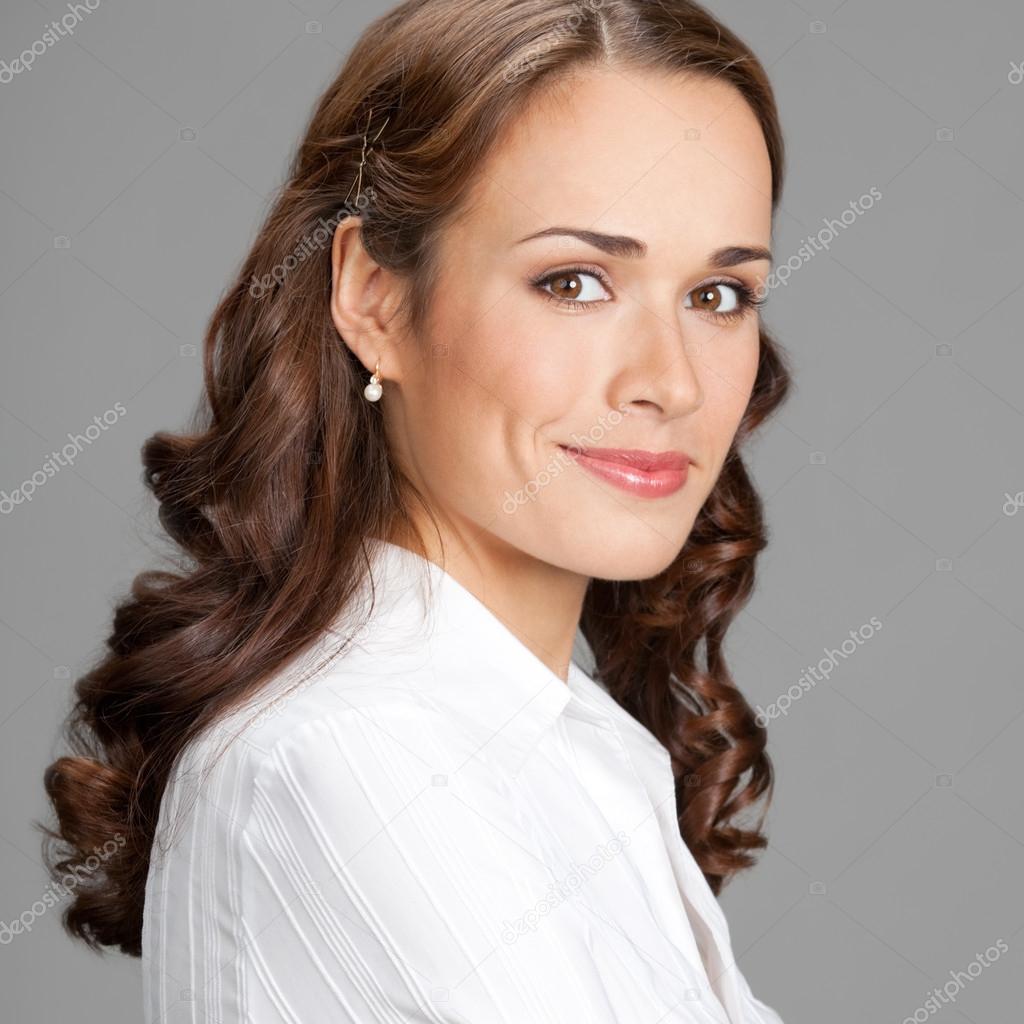 Smiling businesswoman, over gray