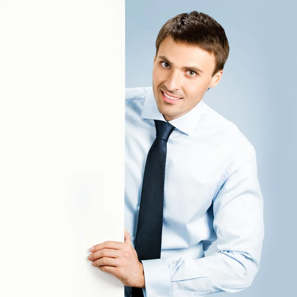 Business man showing blank signboard, over blue — Stock Photo, Image