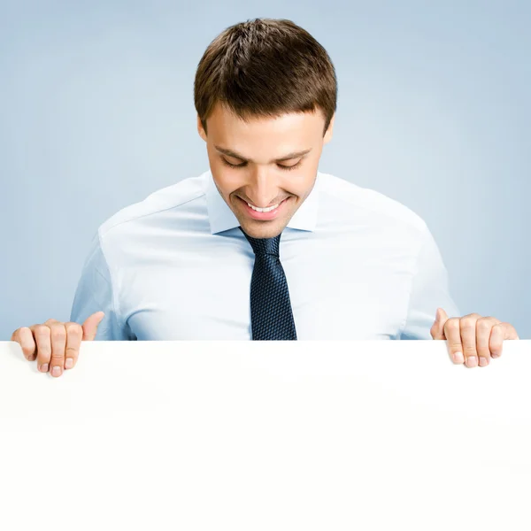 Business man showing blank signboard, over blue — Stock Photo, Image