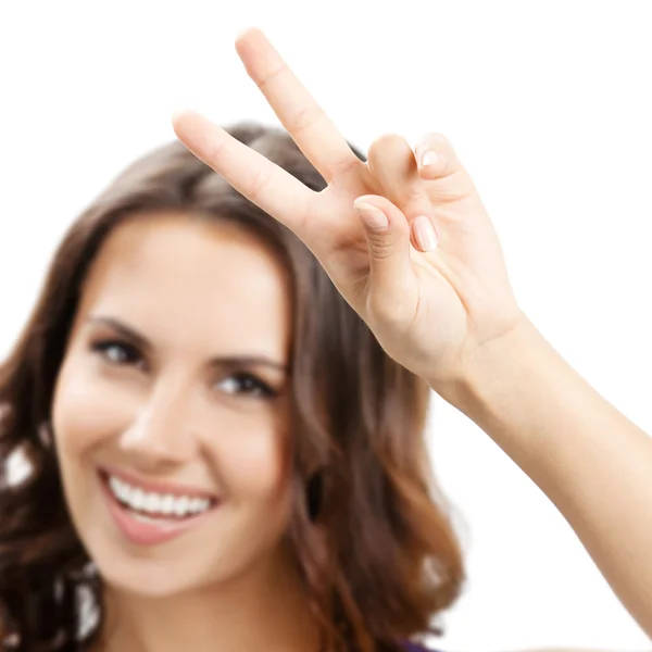 Žena ukazuje dva prsty nebo vítězství gesto, na bílém pozadí — Stock fotografie