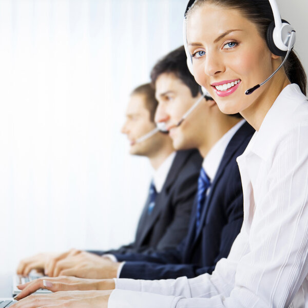 Three support phone operators at workplace