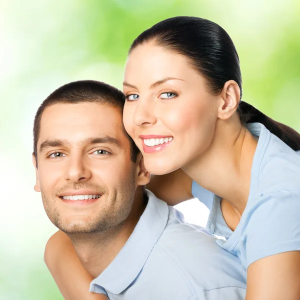 Young happy smiling attractive couple, outdoors — Stock Photo, Image