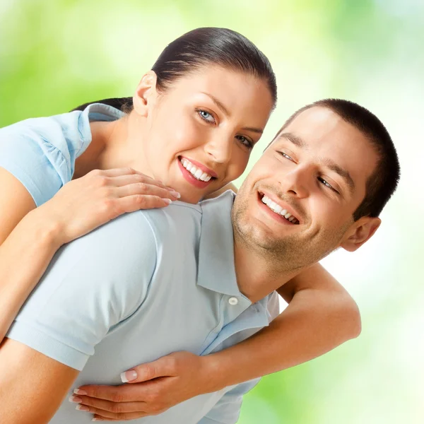 Young happy smiling attractive couple, outdoors Stock Image