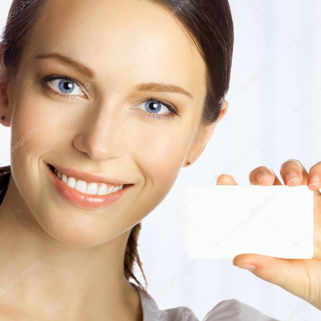 Business woman giving blank business card, at office