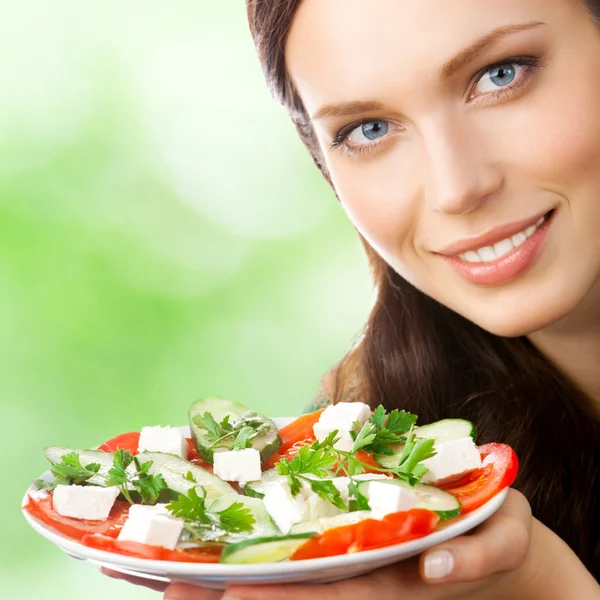 Portrait of happy smiling woman with plate of salad Stock Photo