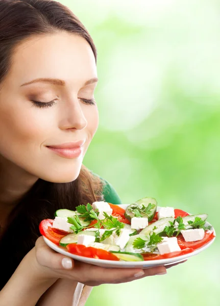 Portrait of happy smiling woman with plate of salad Stock Photo