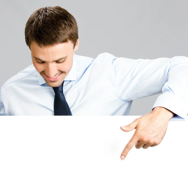 Business man showing blank signboard, over gray — Stock Photo, Image