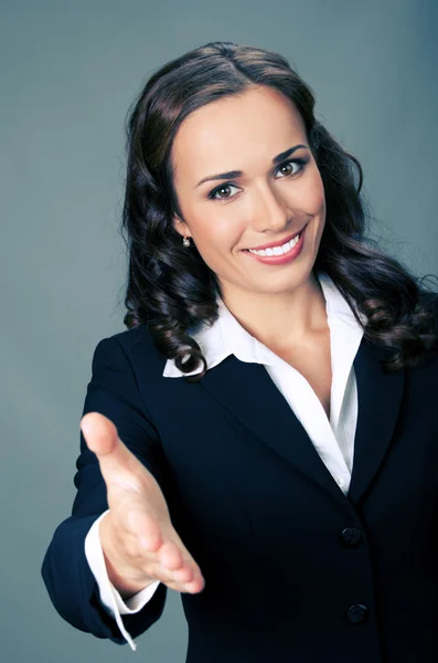 Empresaria dando la mano para el apretón de manos, sobre gris — Foto de Stock