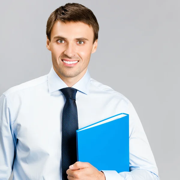 Portrait of business man with folder, over gray — Stock Photo, Image