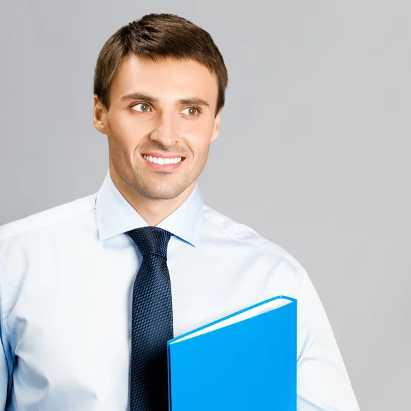 Portrait of business man with folder, over gray — Stock Photo, Image