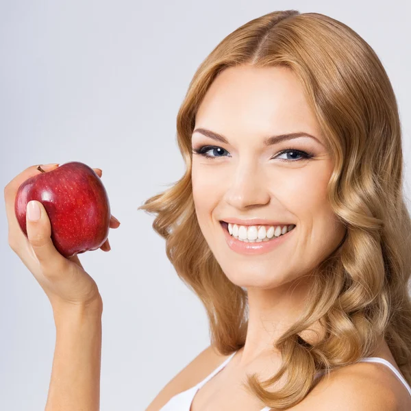 Mujer con manzana, sobre gris —  Fotos de Stock