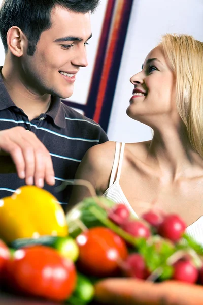 Young attractive happy smiling couple cooking at kitchen Stock Image