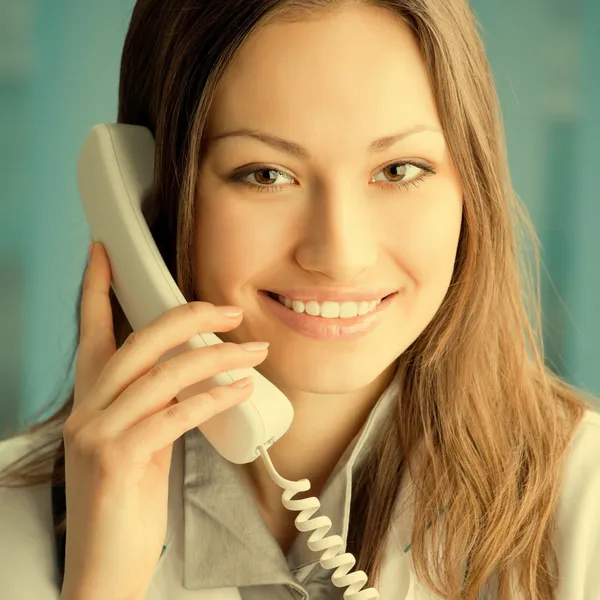 Young doctor on phone, at office — Stock Photo, Image