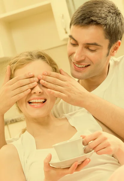 Cheerful smiling young couple, indoors — Stock Photo, Image