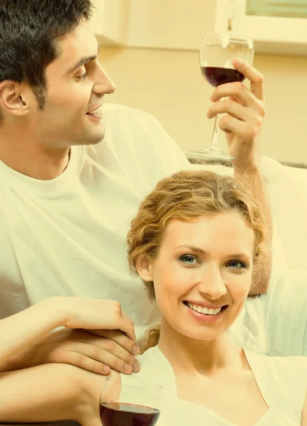 Cheerful couple with glasses of redwine — Stock Photo, Image