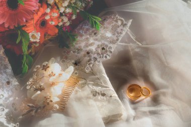 Still life with wedding rings and wedding bouquet