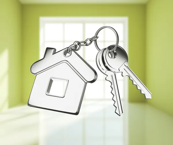 Key with keychain on white rooms — Stock Photo, Image