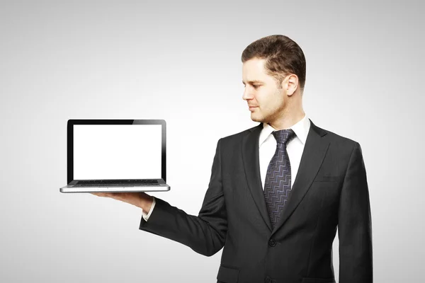 Businessman holding laptop — Stock Photo, Image