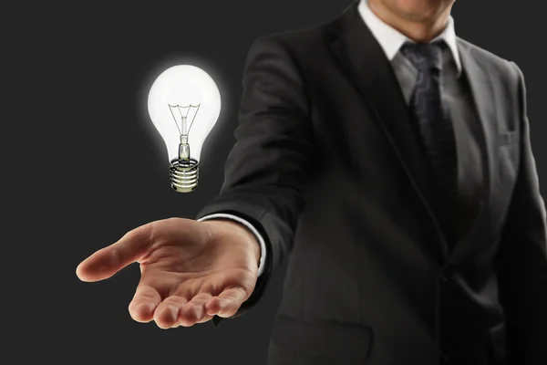 Man holding lightbulb — Stock Photo, Image