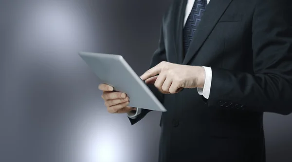 Businessman pushing tablet — Stock Photo, Image