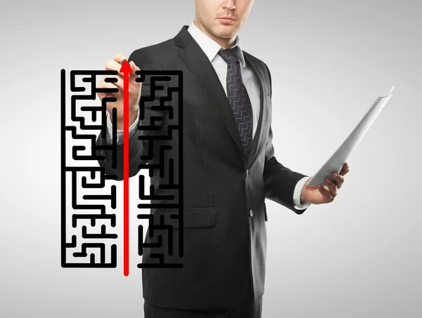 Businessman drawing labyrinth — Stock Photo, Image