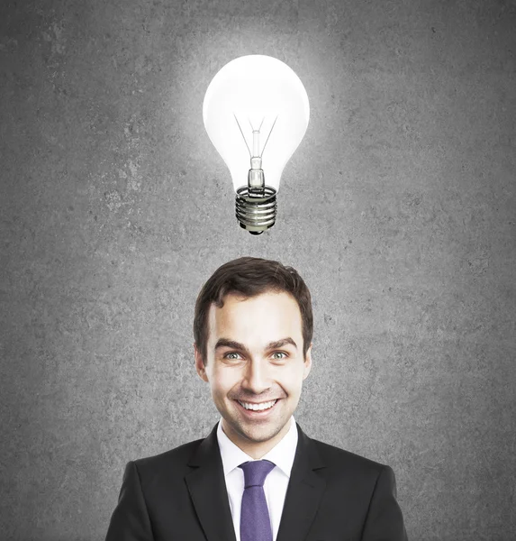 Businessman with lamp — Stock Photo, Image