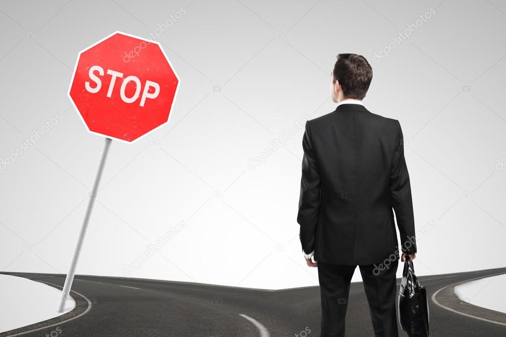 man looking at a stop sign