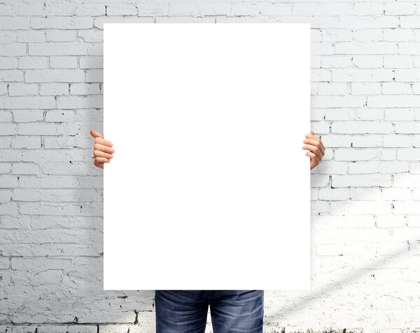 man holding white poster