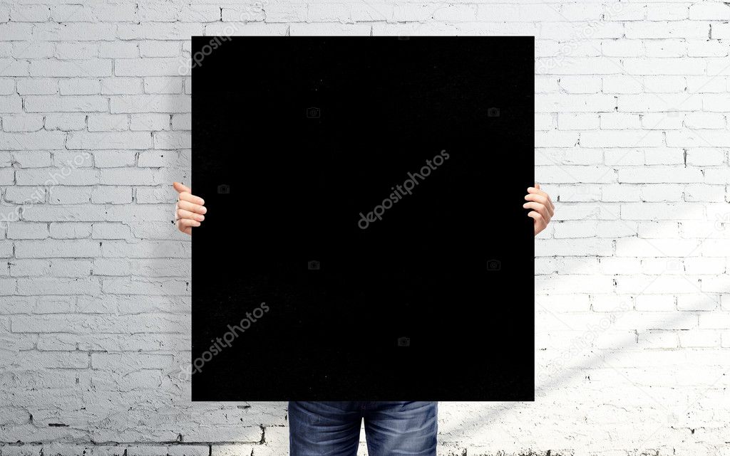 man holding black poster