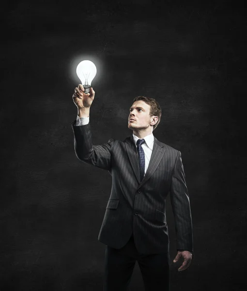Podnikatel a lampa — Stock fotografie