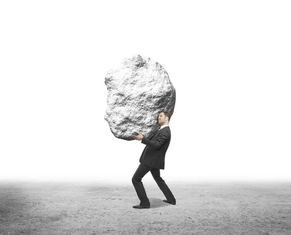 Hombre de negocios sosteniendo roca — Foto de Stock