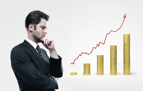 Man looking on coins chart — Stock Photo, Image