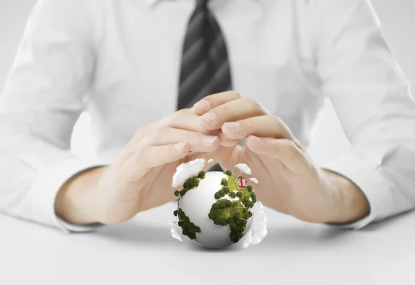 Hands covering small earth — Stock Photo, Image