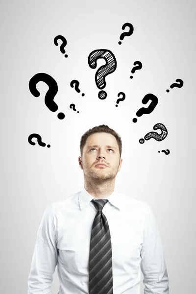 Man with questions symbol — Stock Photo, Image