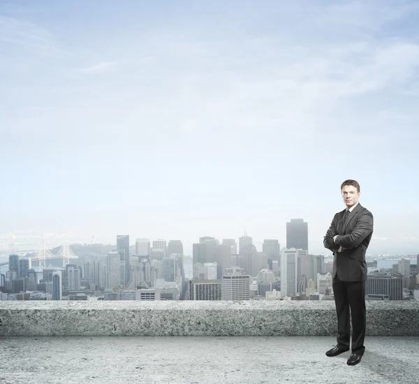 Businessman standing on roof — Stock Photo, Image