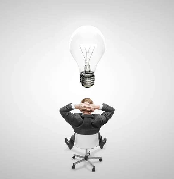 Man drawing lamp over head — Stock Photo, Image