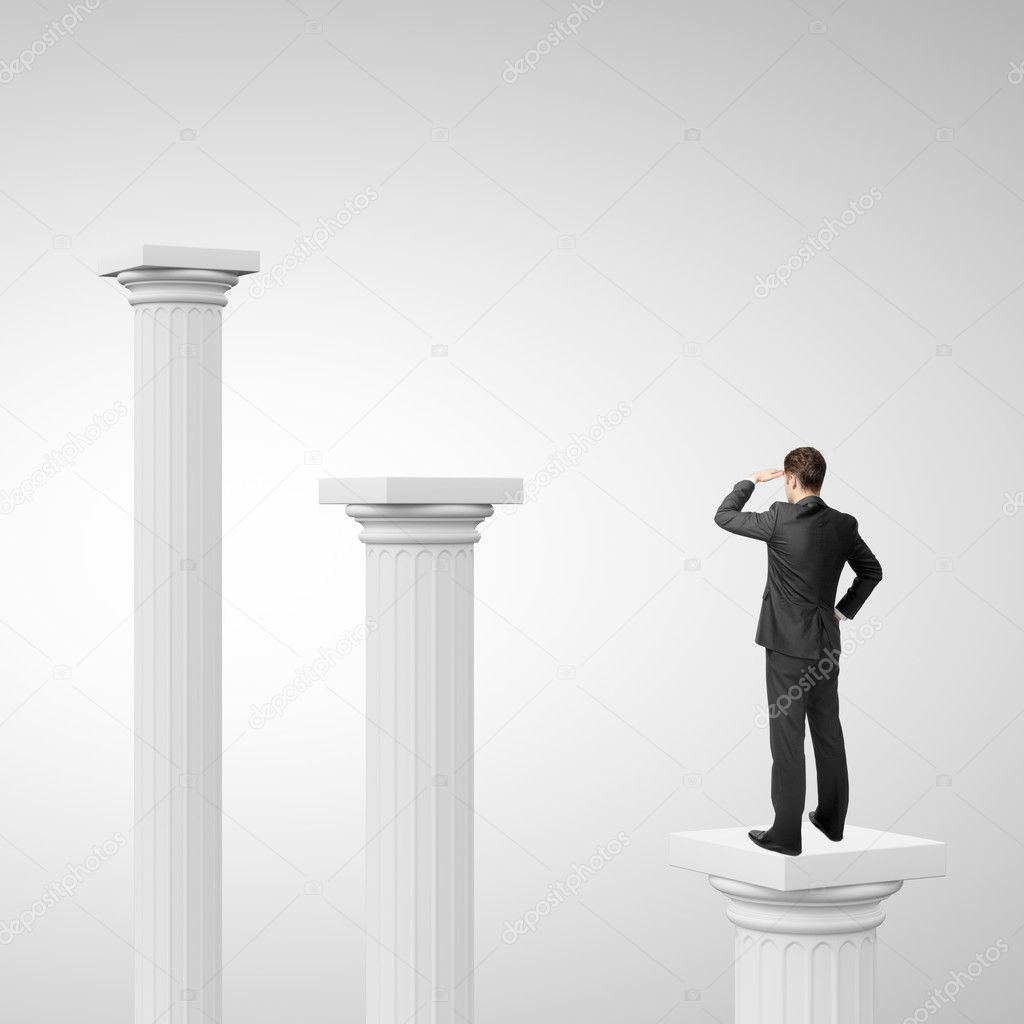 businessman on column