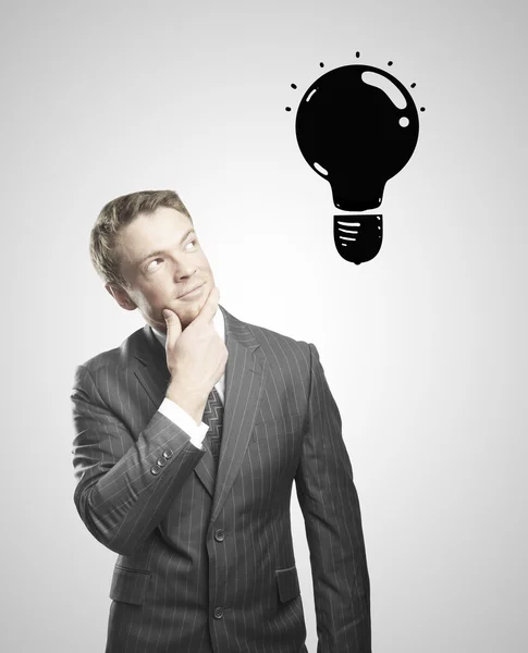 Empresário e lâmpada de desenho — Fotografia de Stock