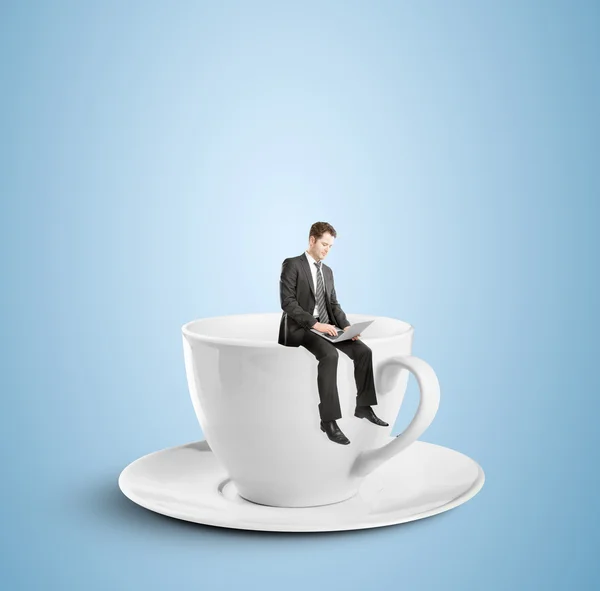 Man sitting on cup — Stock Photo, Image