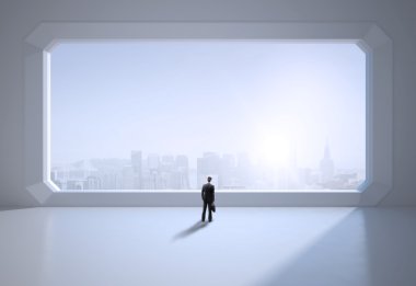 büyük pencere duran işadamı