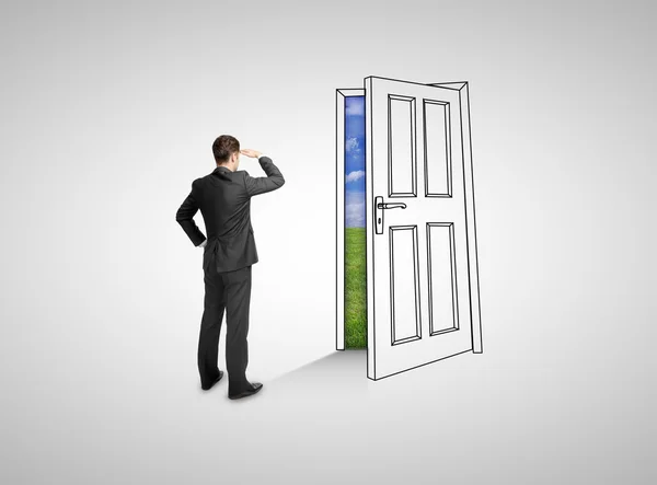 Businessman looking at drawing door — Stock Photo, Image