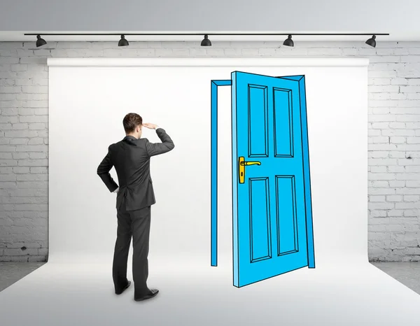 Бизнесмен смотрит на чертежную дверь — стоковое фото