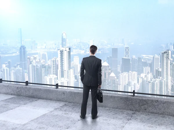 Businessman looking at city — Stock Photo, Image